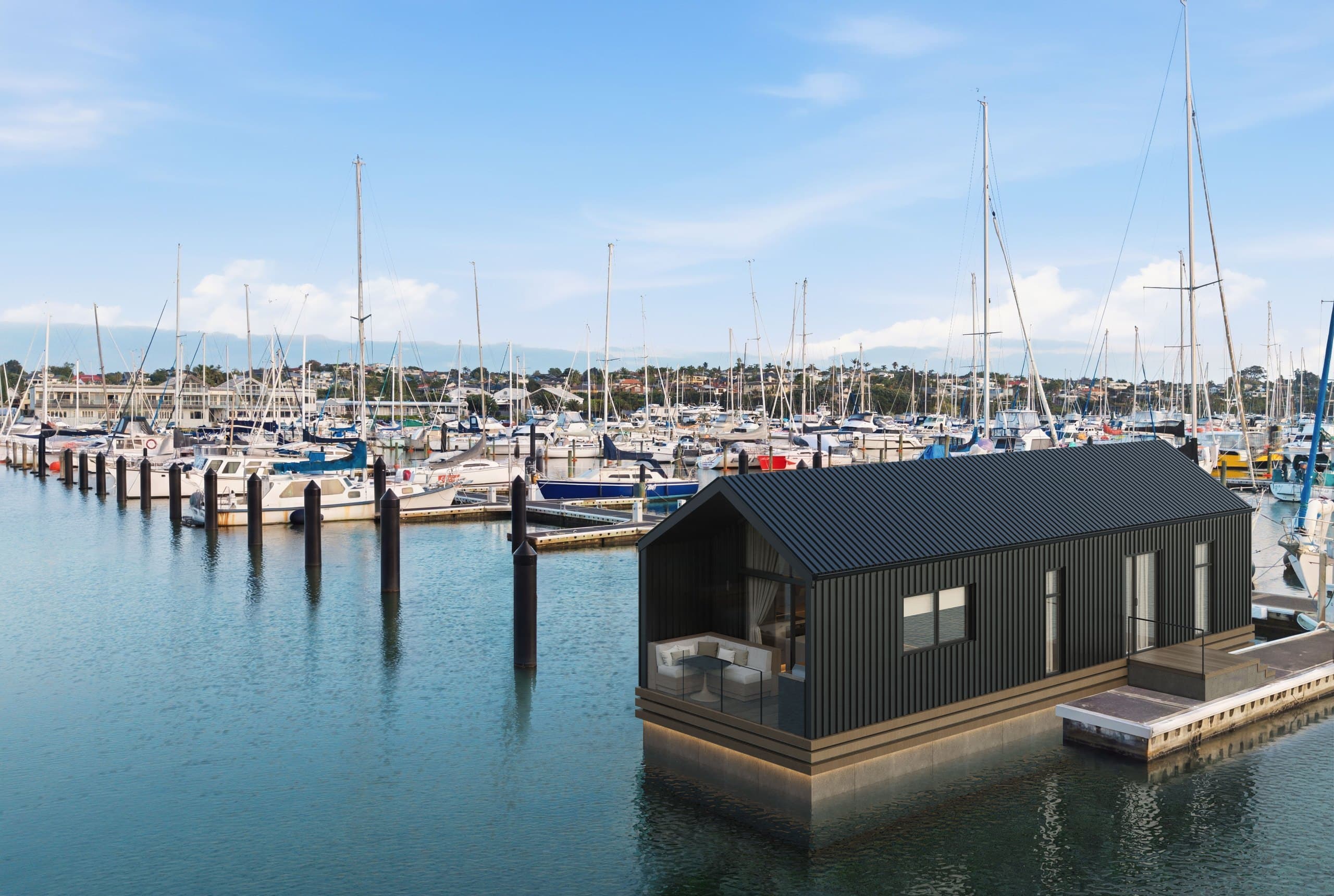 Aerial side render of a Boathouse Residence with dark cladding and a wraparound deck