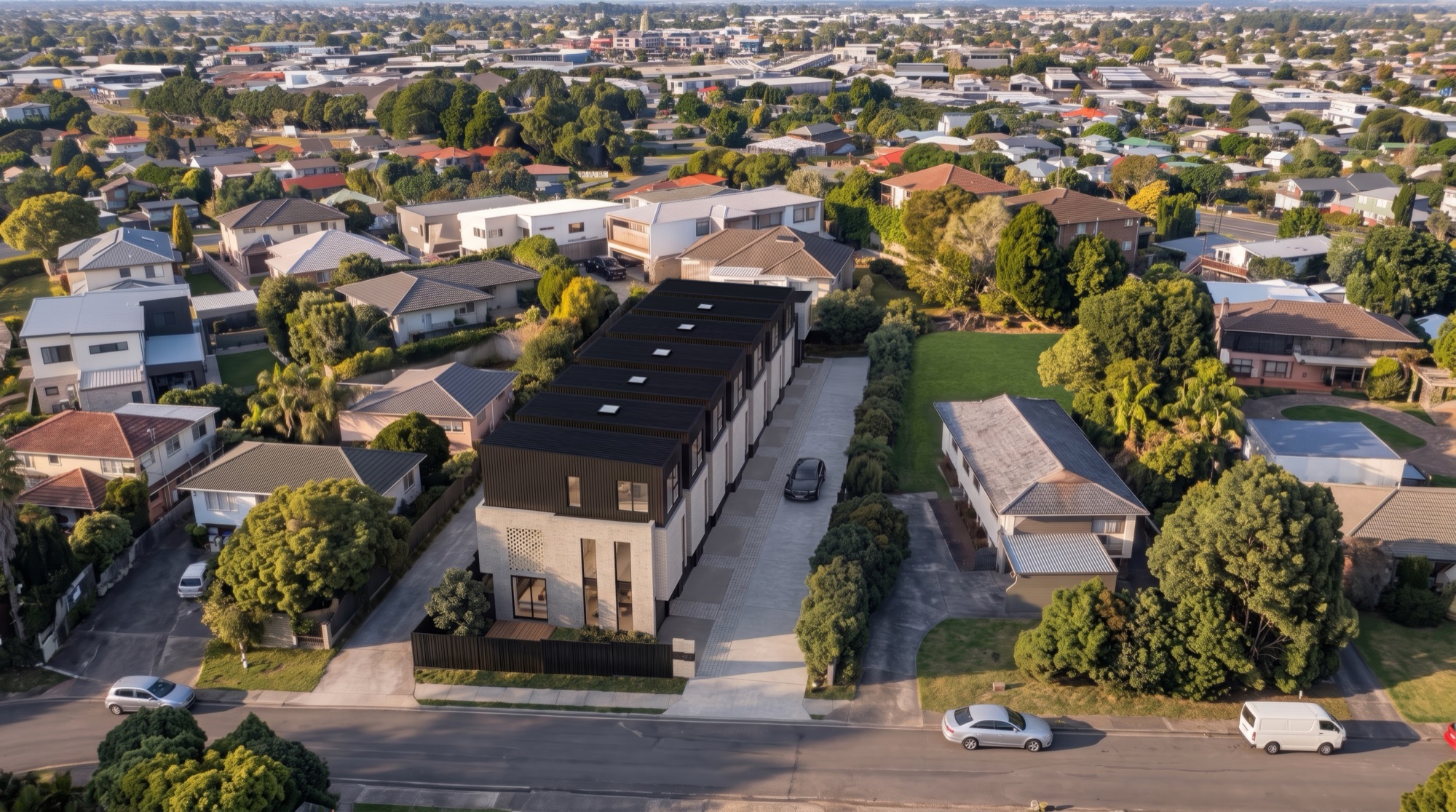 Photorealistic aerial render of the Ludlow Terrace townhouses among Tōtara Vale streets by Render Works