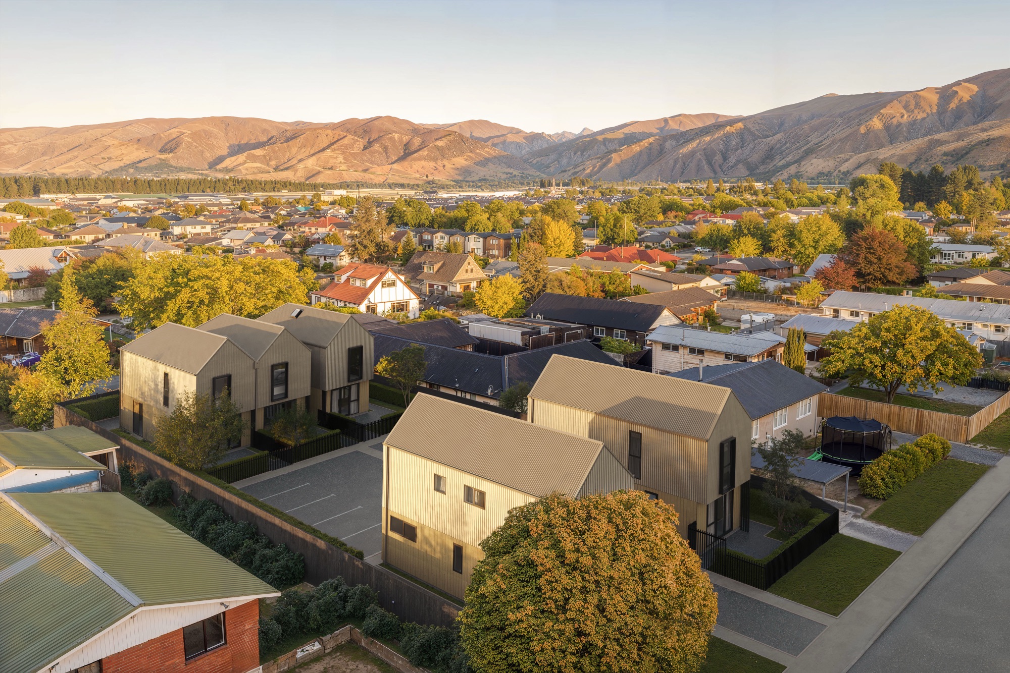 Aerial architectural render of the Molyneux homes composited into real drone photography of the Cromwell site, by Render Works